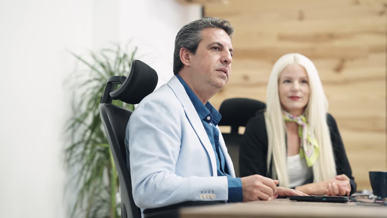 Professional Man Speaking and Gesturing During an Office Meeting