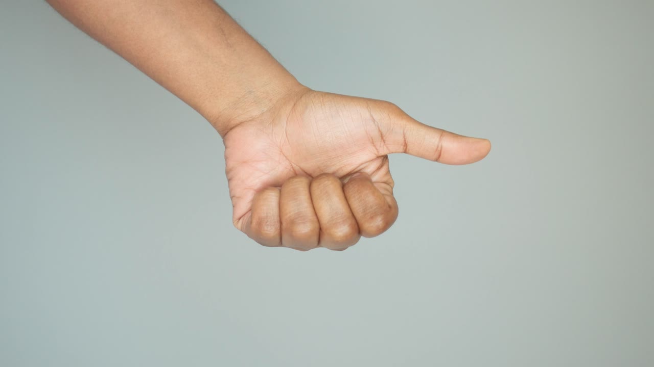 Person's hand giving a thumbs-up gesture