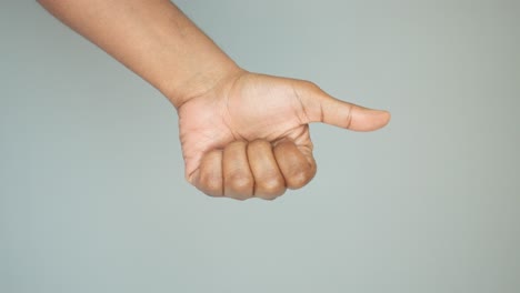 person's hand giving a thumbs-up gesture
