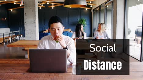 Animation-of-a-sign-SOCIAL-DISTANCE-over-people-working-in-a-coffee-shop