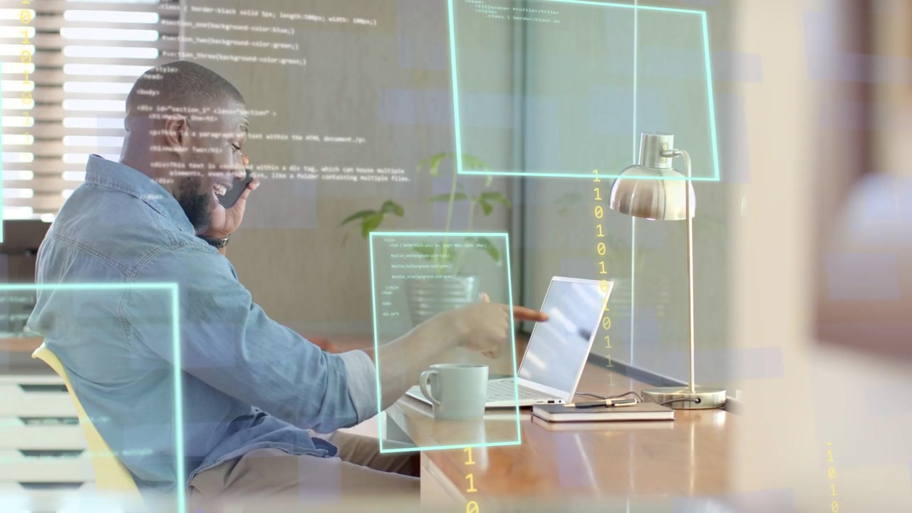 Man answering phone while tapping laptop in tech office, holographic code over screen, closing call
