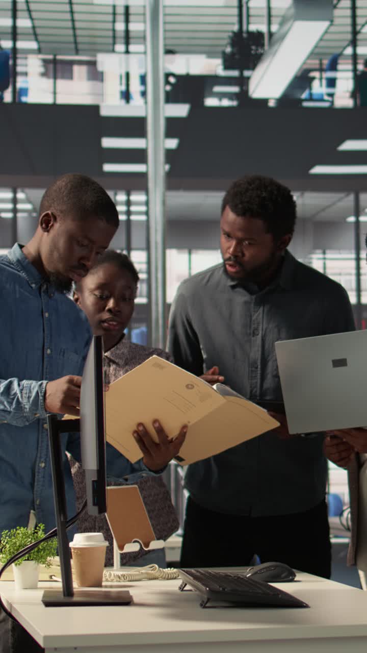 African American Business Team Collaborating on Project in Modern Office