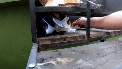 Slow-motion-video-of-a-white-man-starting-to-light-the-fire-on-the-grill-with-a-match