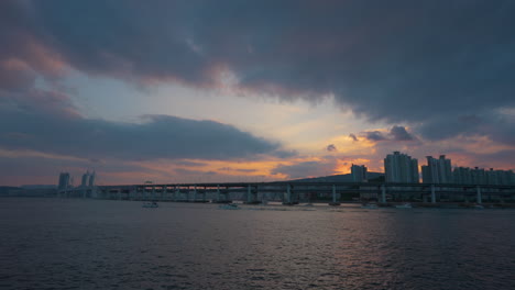 dramatic sunset sky above gwangandaegyo or diamond bridge in busan in summer evening