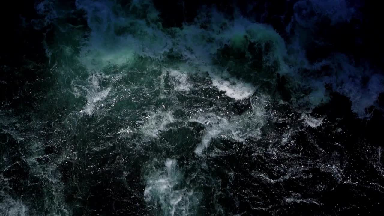 Closeup of River with strong current, splashing waves and foam
