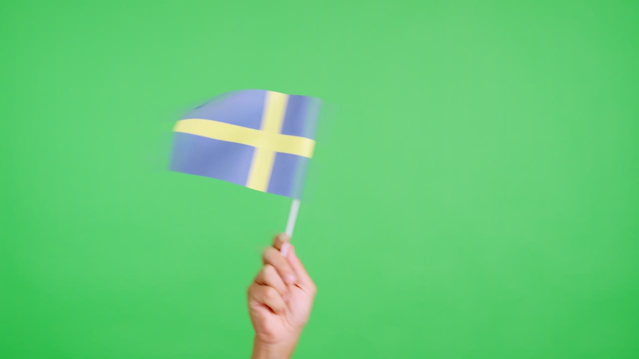 Hand waving a pennant of a swedish national flag