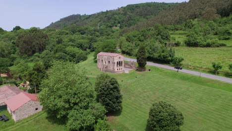 Aerial-view-from-distance-of-pre-romanesque-Santa-Maria-del-Naranco-church-located-in-Oviedo,-in-Asturias,-Spain