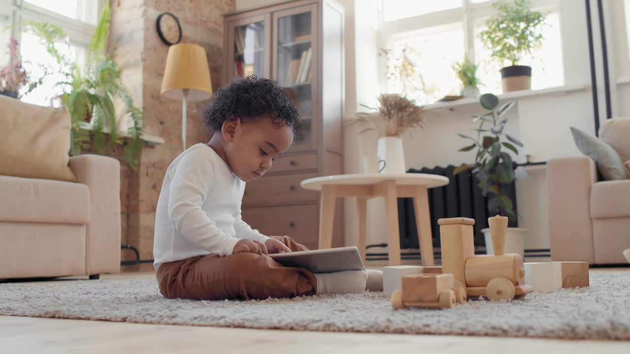 Adorable Toddler Boy Playing on Tablet