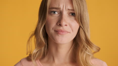 caucasian woman raising eyebrow on camera.