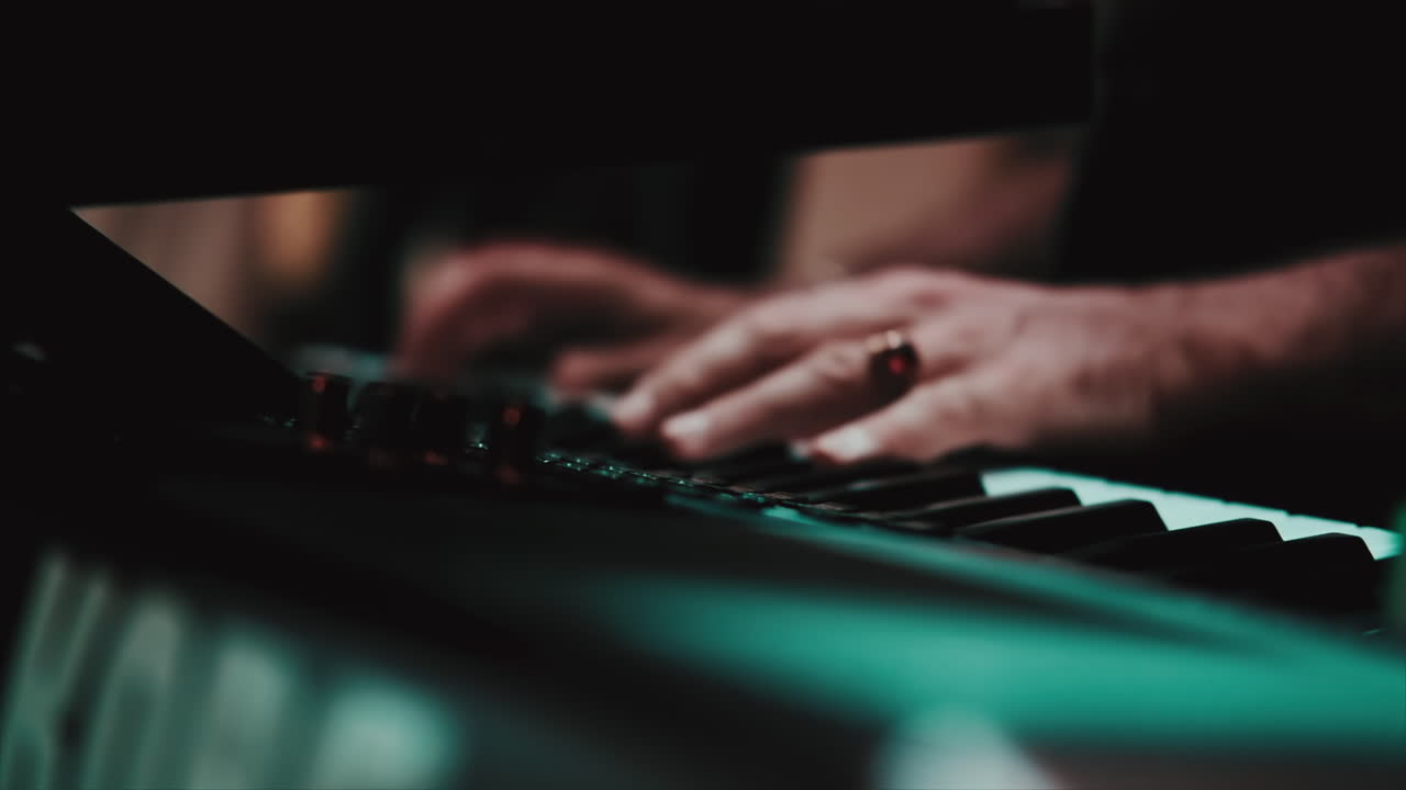Musicians playing at a wedding. Man is playing synthesizer. Stage lights