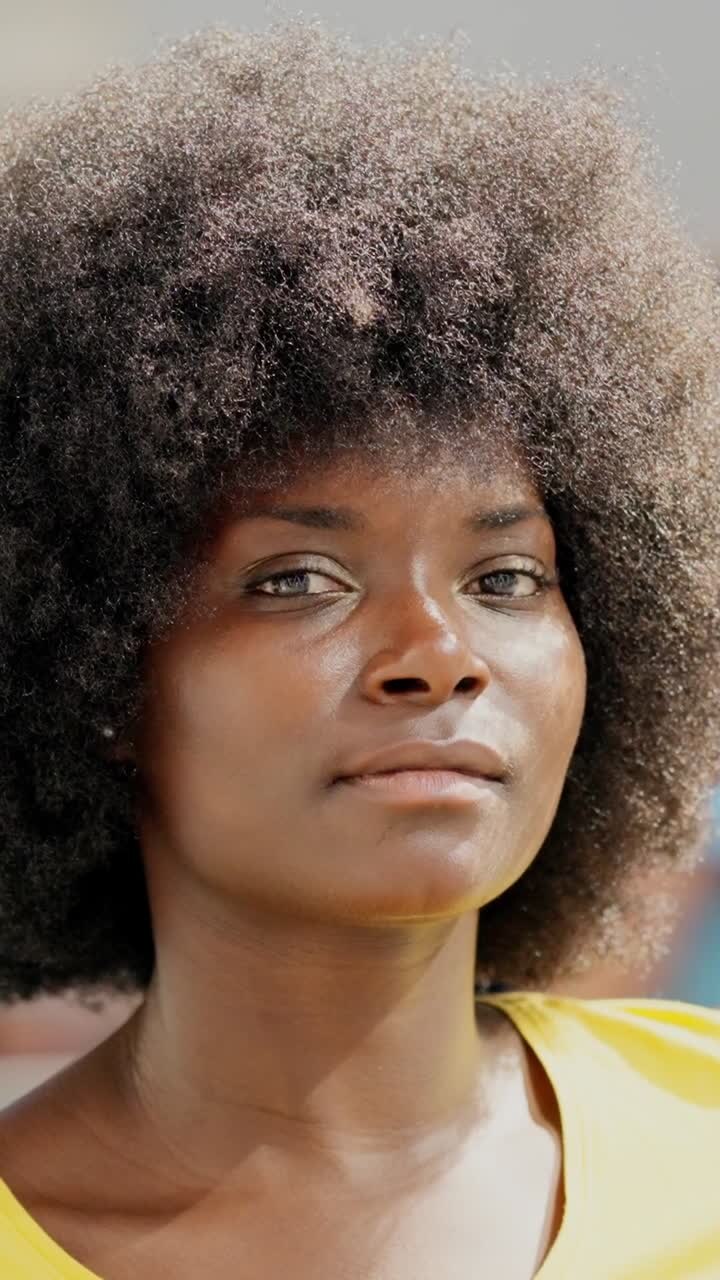 Close-up portrait of a woman with an afro hairstyle
