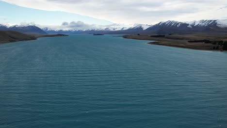 aerial view of lake tekapo with ripples on the surface in south island, new zealand