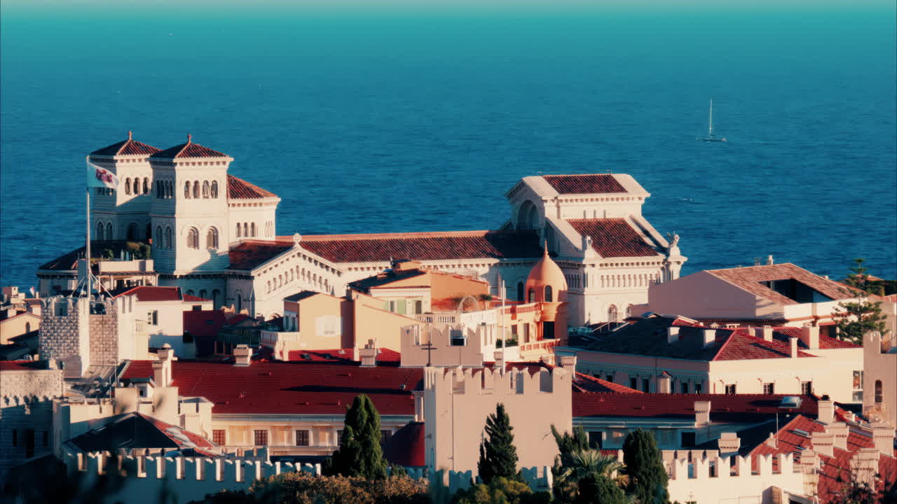Distant aerial view of the Prince's Palace in the skyline of Monaco with the sea on the background