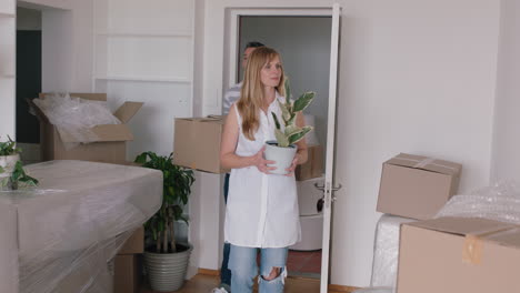 young-couple-moving-house-new-home-owners-smiling-enjoying-successful-move-embracing-in-apartment