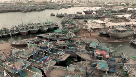 fishing boats moored along jetties at ibrahim hyderi in karachi