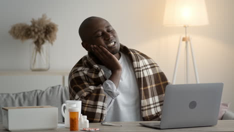 man working from home while sick