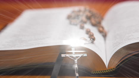 animation of christian rosary on bible on with glow on orange background