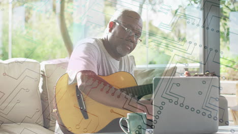 man playing guitar while using laptop, with circuit pattern animation overlay