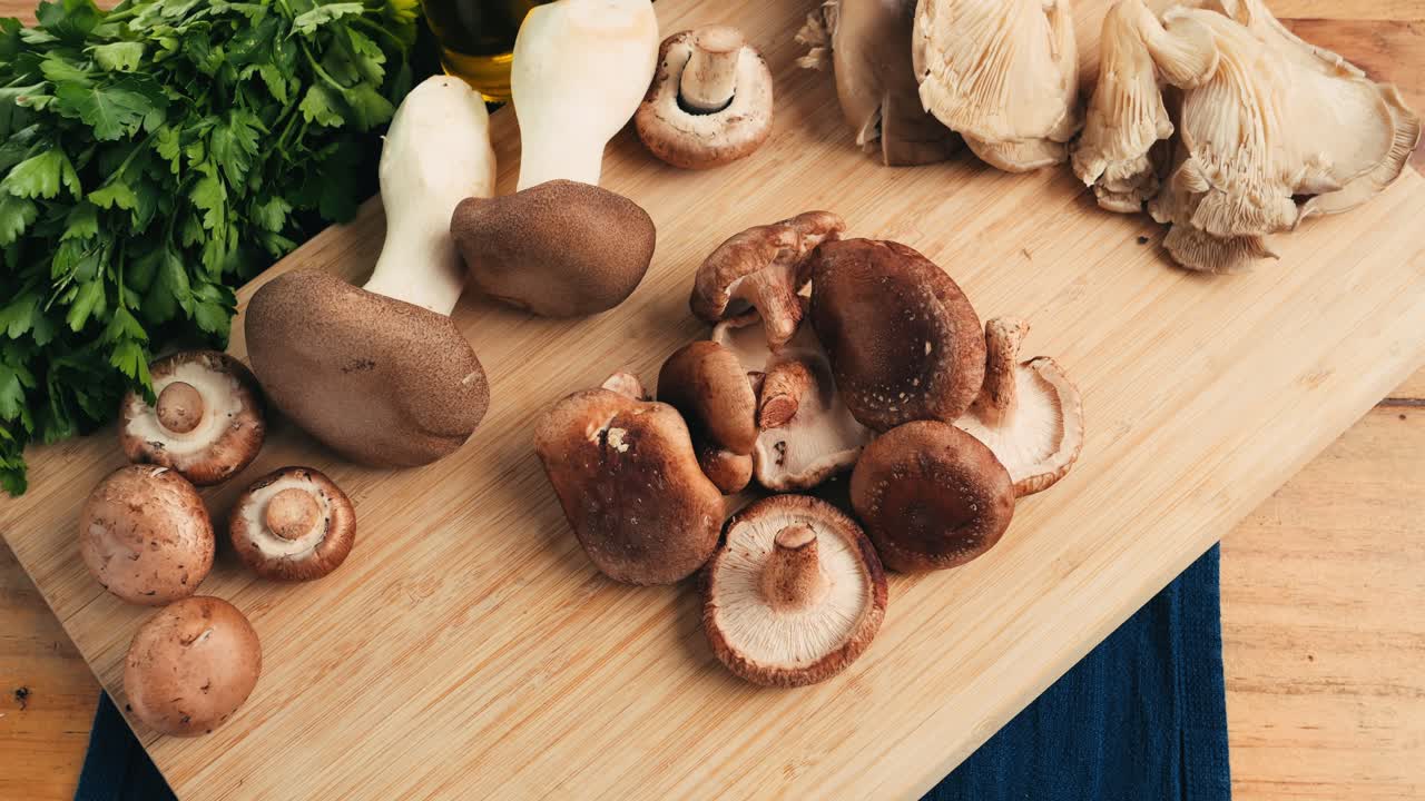 Assortment of Mushrooms on a Wooden Cutting Board