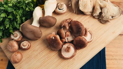 assortment of mushrooms on a wooden cutting board