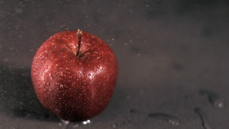 water sprayed on apple in super slow motion