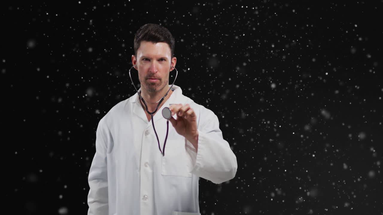 Male doctor holding stethoscope in studio backdrop, presenting floating particles for health data