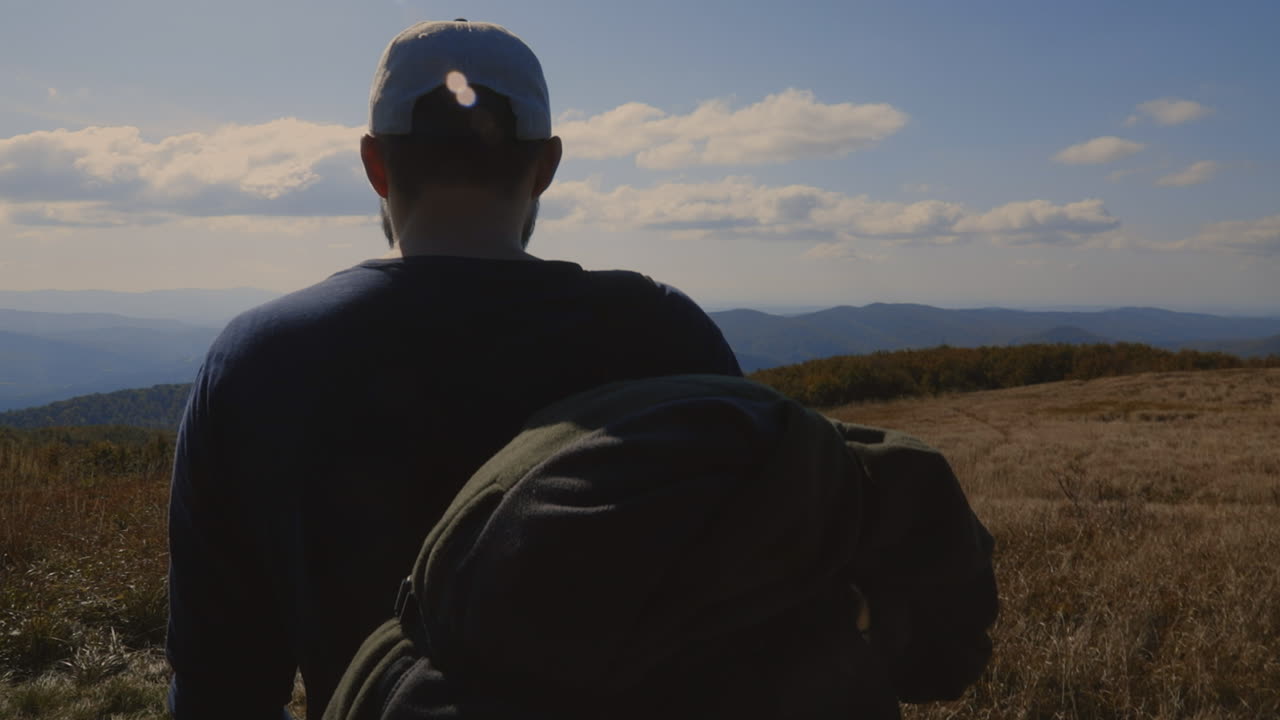 Backpacker and his dog at the top of the hill