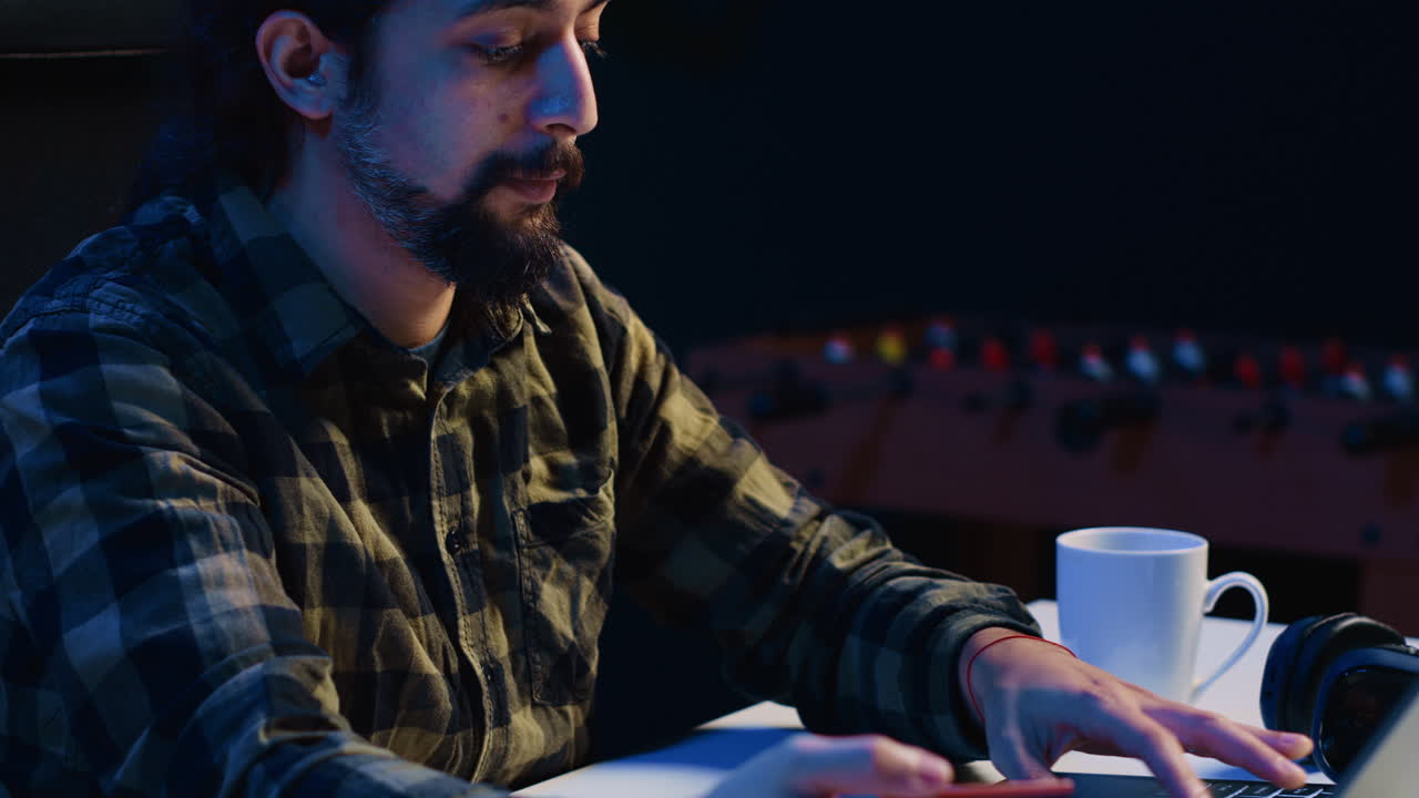 Man spending money while doing online shopping, typing debit card information