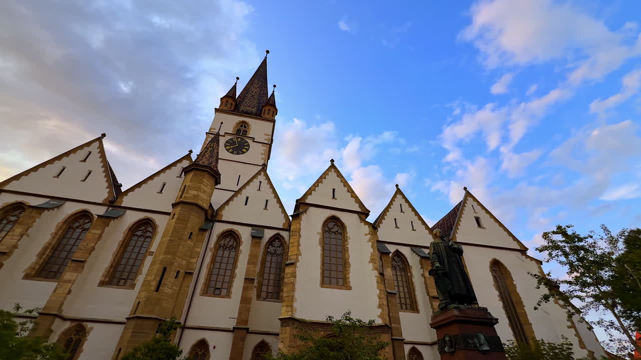 Sibiu, Romania, 17 July 2025: Beautiful Lutheran Cathedral of Saint Mary in Sibiu, Romania. Low angle view at the building against blue cloudy sky