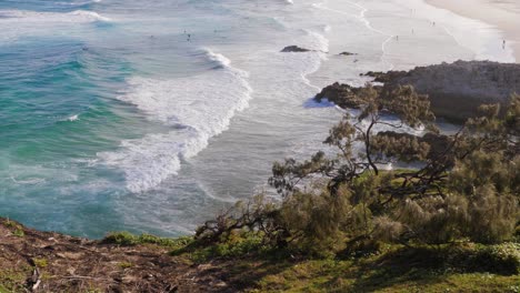 Foamy-Waves-Washing-up-On-Beach---South-Gorge-Beach-In-Point-Lookout-QLD,-Australia-During-Daytime---wide-shot