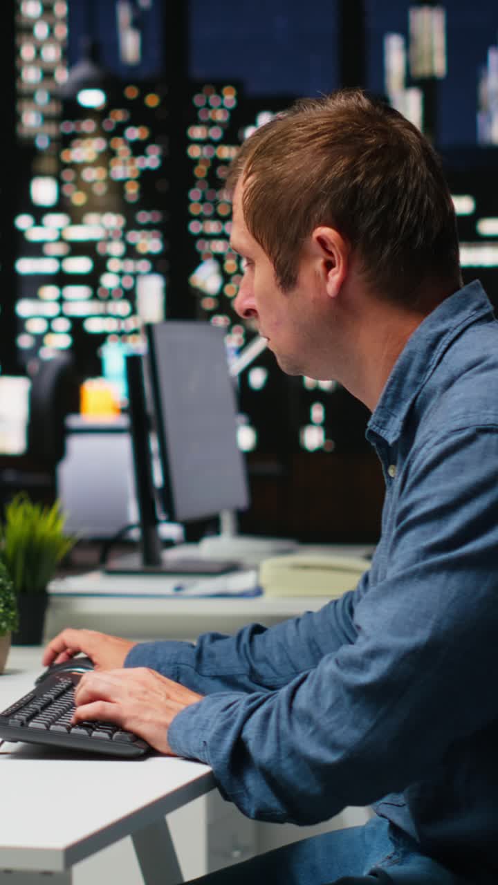 Vertical Video Male IT engineer uses AI techniques to create video game and a turbine