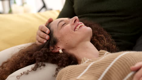 Couple,-relax-and-smile-of-woman-on-sofa-laughing