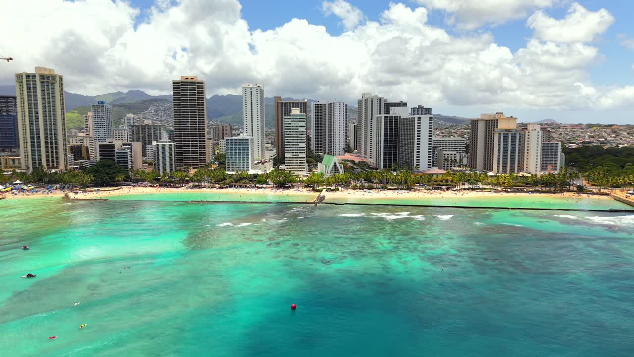 Iconic aerial view of Waikiki Beach and Honolulu on a sunny day