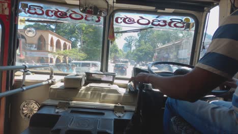 interior shot of bus in sri lanka driving down busy road on a sunny days