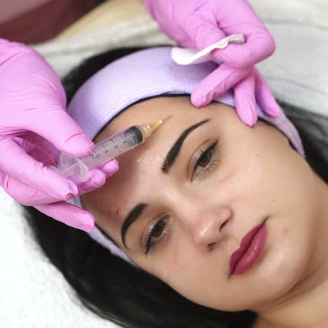 Woman receiving facial injections at a spa