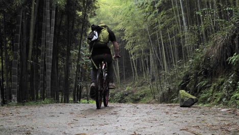 4k mountain biker uphill moganshan, china