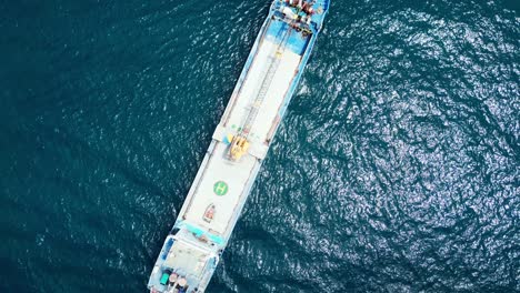 Aerial-Top-View-of-Large-Empty-Cargo-Ship-Traversing-in-Blue-Ocean-in-Virac,-Catanduanes,-Philippines-Asia