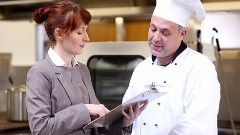 restaurant manager speaking with head chef