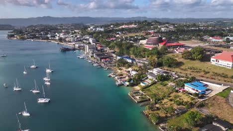 luxury boats at port vila harborside capital of vanuatu in efate island. aerial pullback shot