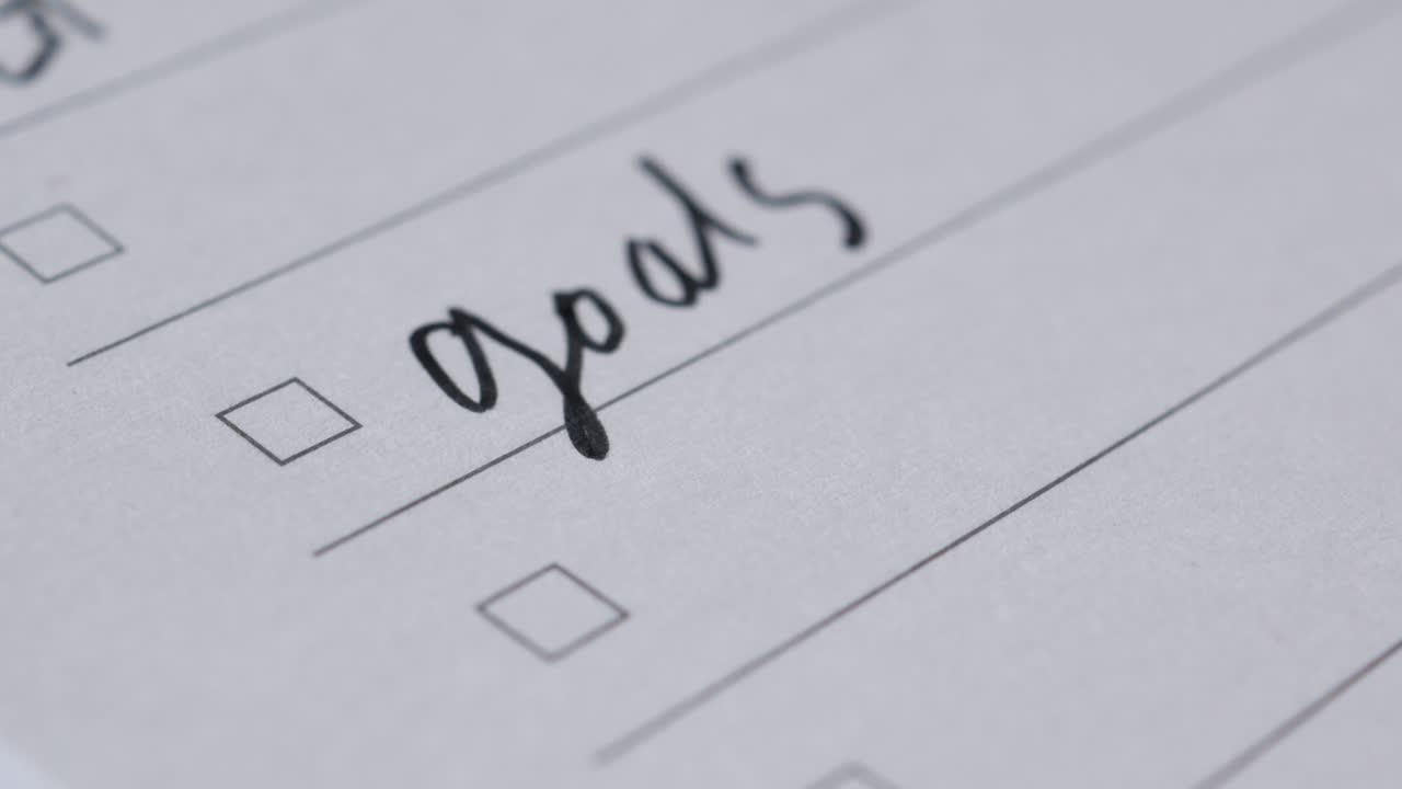 Tick mark on planning goals on notepad ,