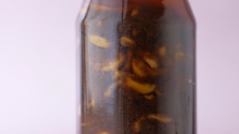 homemade garlic pickle in a glass jar on table ,