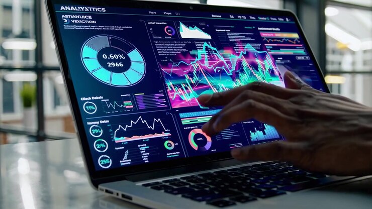 Professional Analyzing Financial Data Charts on Laptop in Modern Office