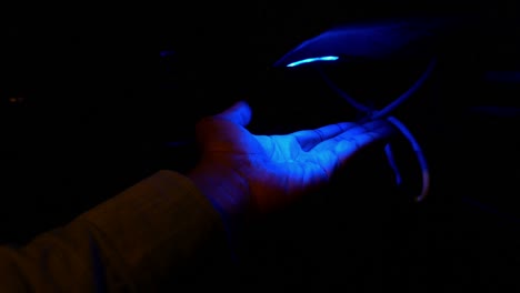 hand being disinfected with uv light