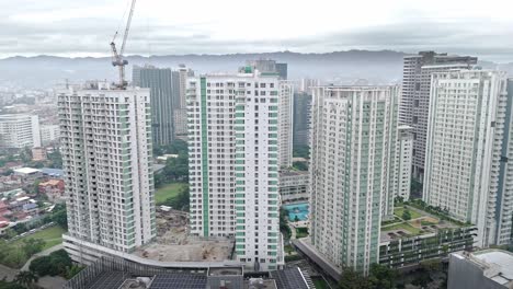 tall white skyscrapers being constructed in cebu city centre - philippines