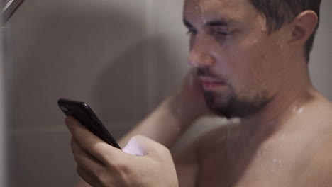man using a phone in the shower