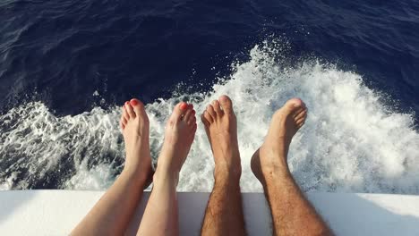 feet on deck of sailboat or yacht sailing in sea