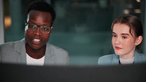 two business professionals collaborating on a computer screen