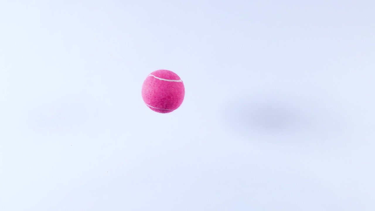 A tennis ball bounces across a surface