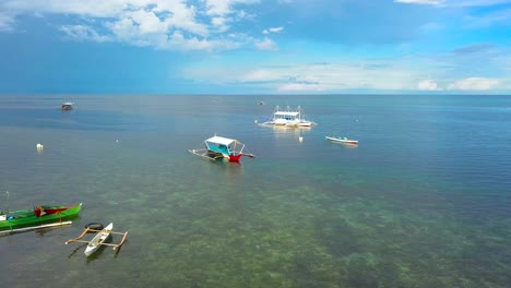 canoas y botes bangka a la deriva en aguas poco profundas en filipinas, tiro de aproximación de drones