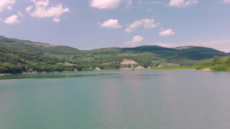 Aerial-footage-with-drone-make-u-turn-over-lake-and-bridges